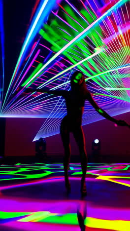silhouette of a dancer amidst colorful laser lights
