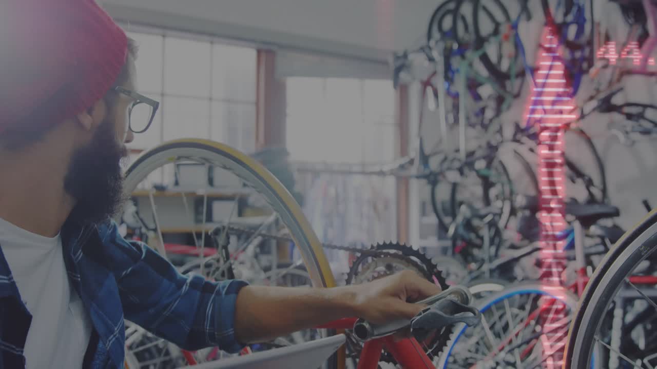 bicycle mechanic scrolling tablet, tapping charts, checking gear and tuning chain for alignment