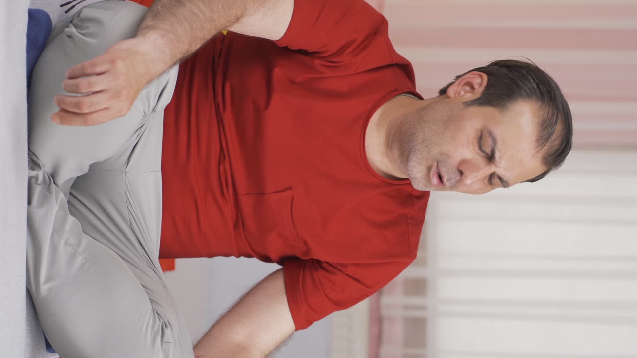 Vertical video of The fainting man. The man faints.