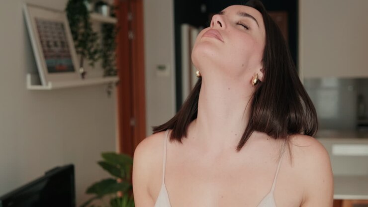 Woman Stretches Her Neck at Home