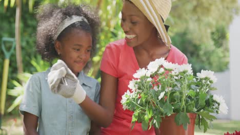 mother and daughter gardening during a sunny day