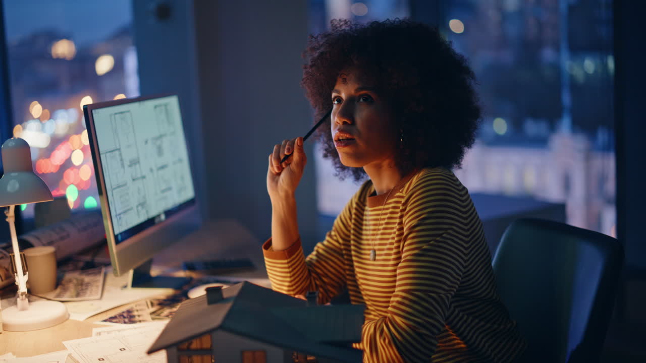 Construction manager working overtime thinking on design at dark office closeup