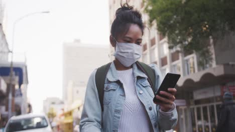 Mixed-race-woman-wearing-coronavirus-medical-mask-on-the-street