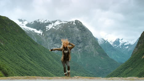 woman hiking and dancing in norwegian fjords