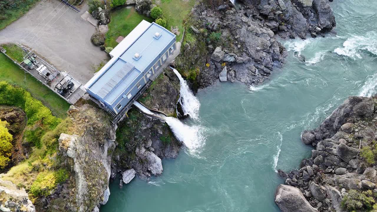 Drone footage captures the Kawarau Gorge hydroelectric plant in Queenstown, New Zealand, highlighting the flowing river and rugged landscape