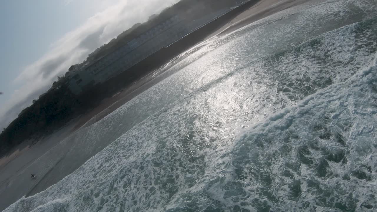 Breathtaking aerial view tracking waves in Europe during a stunning sunrise