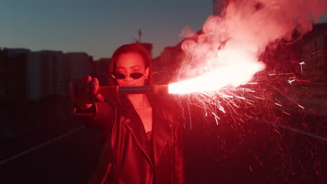 independent woman holding flare in city at sunrise rebellious girl protesting for equality in street with firework female millennial freedom movement