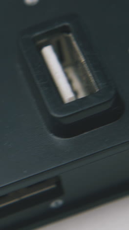 motion over modern usb hub in black plastic case on clean white background extreme close view