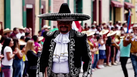 man in traditional mariachi charro suit and sombrero at a cultural festival