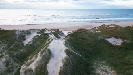 Dune-landscape-with-footpath-leading-to-a-serene-beach