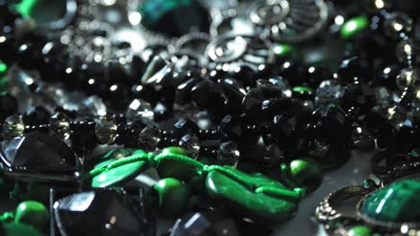 jewelry, beads. close-up. rotation. beautiful shiny, sparkling jewelry with glare in gems. macro. a lot of beads in different colors. various jewelry, stone products, green malachite beads