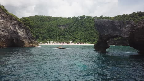 low-water-level-aerial-past-rugged-stone-cliffs