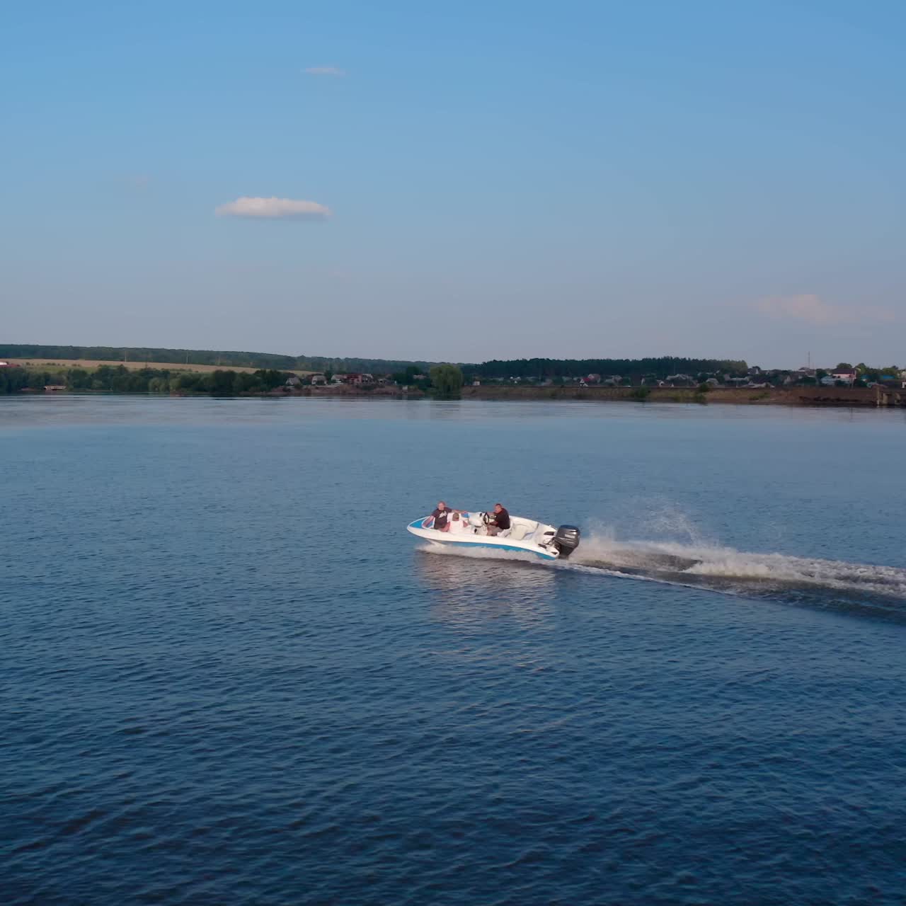 Motor boat sails along the river