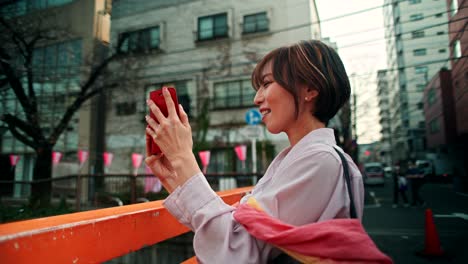 woman taking a picture in a japanese city