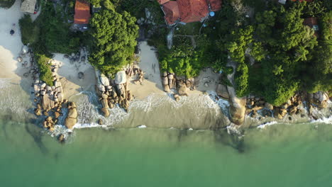 drone aerial top down view beach with turquoise colored water sunset, jurere internacional, florianopolis, santa catarina, brazil