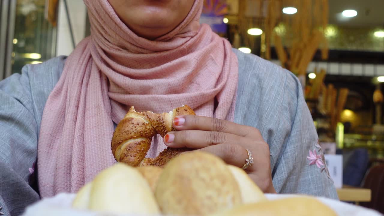 Woman Eating Turkish Bread (Simit)