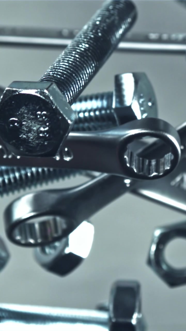 Close-up View of Metal Wrenches, Bolts, and Nuts