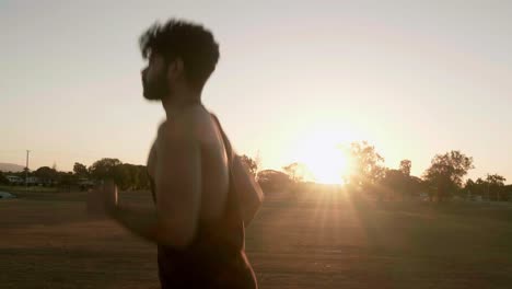 Indian-guy-running-and-trainning-for-cardio-exercise-on-public-park-during-sunset