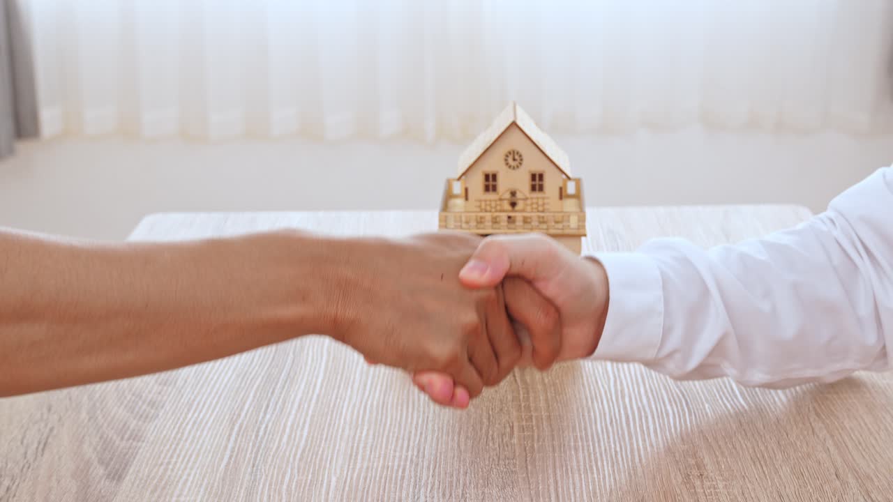 Real Estate Agent Holding House Key To His Client