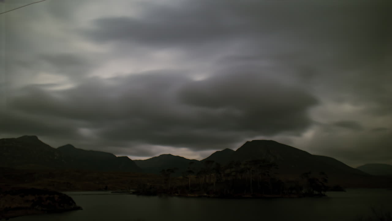 Timelapse of Pine Island under cloudy full moonlight, with the Twelve Bens in the background. Connemara
