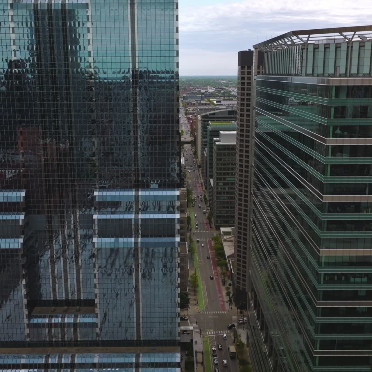 Cars moving along the roads of Chicago among the skyscrapers. Wonderful architecture of metropolis at daytime