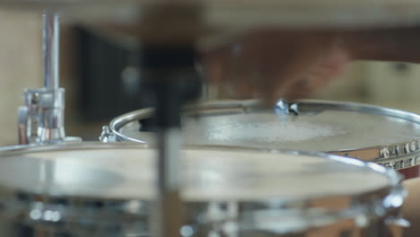 african american drummer using drum set