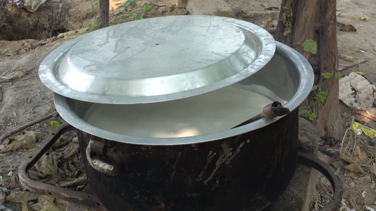 Boiling Milk in a Large Pot Outdoors