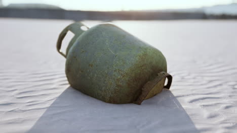 old rusted metal gas tank on the beach