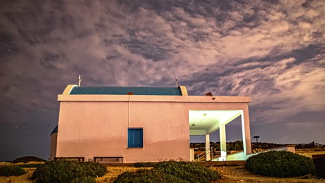 a remarkable photograph of ayioi anargiroi church, cyprus, skillfully captured amidst the dynamic cloud movement in a timelapse fusion