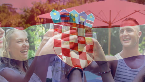 clinking glasses in outdoor celebration with croatian flag animation overlay