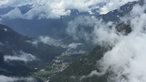 drone-aerial-view-of-valchiavenna-valley-in-northern-italy,-side-reveal-through-the-clouds