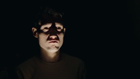 close-up of a man's face in shadow