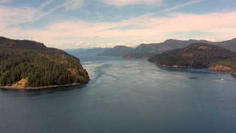 High-Altitude-Adventure:-Drone-Over-Water-Reveals-Ripple-Rock-and-Tree-Covered-Mountains