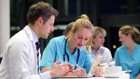 doctors and nurse discussing with each other in conference room