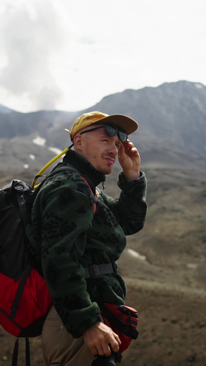 Hiker Photographer Taking Pictures in Rugged Mountain Landscape