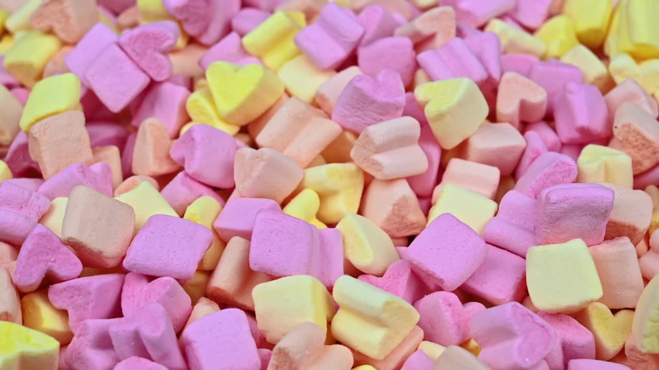 Young lovely couple relaxing head to head on the bed. Woman smile and looking at the partner. Valentines day. Close up. Overhead view. Relationships and feelings concept. Slow motion