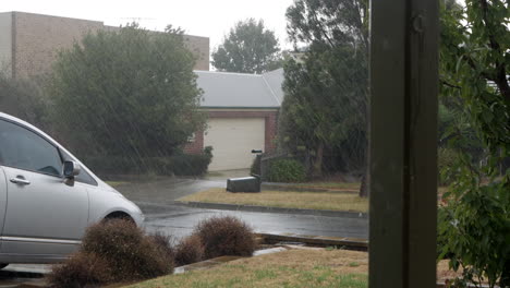 wild hail storm in a suburban street during the end of summer