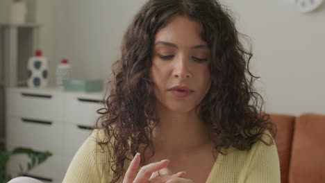 female beauty blogger comparing two foundations and talking to camera