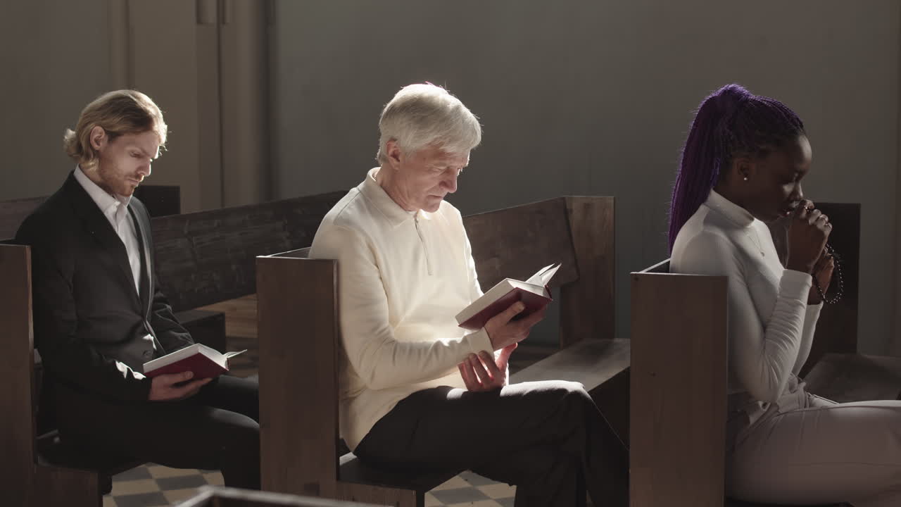 Three Multiethnic Parishioners Praying in Catholic Church