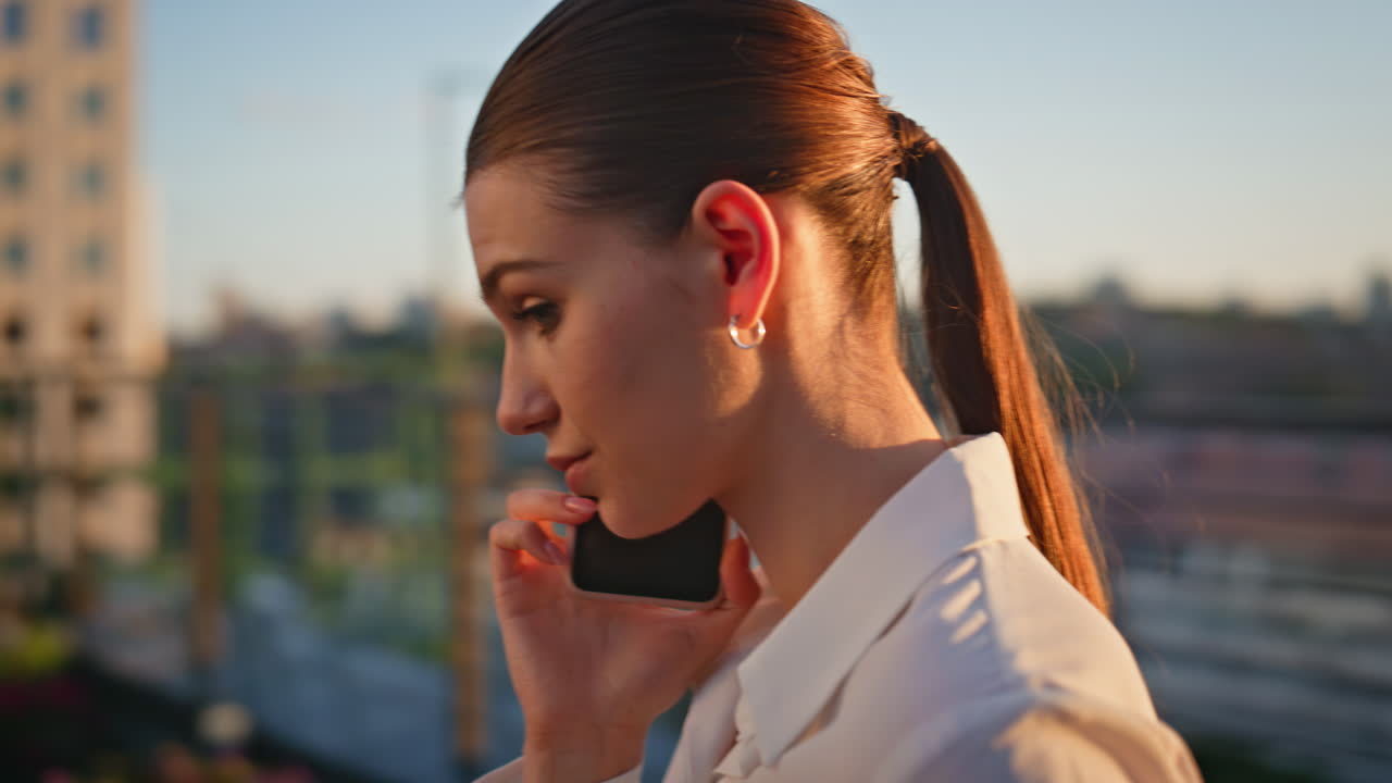 Calling lady discussing work on sunset terrace closeup. Worried woman talking