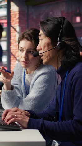 vertical video call center team leader supervising agent helping customers