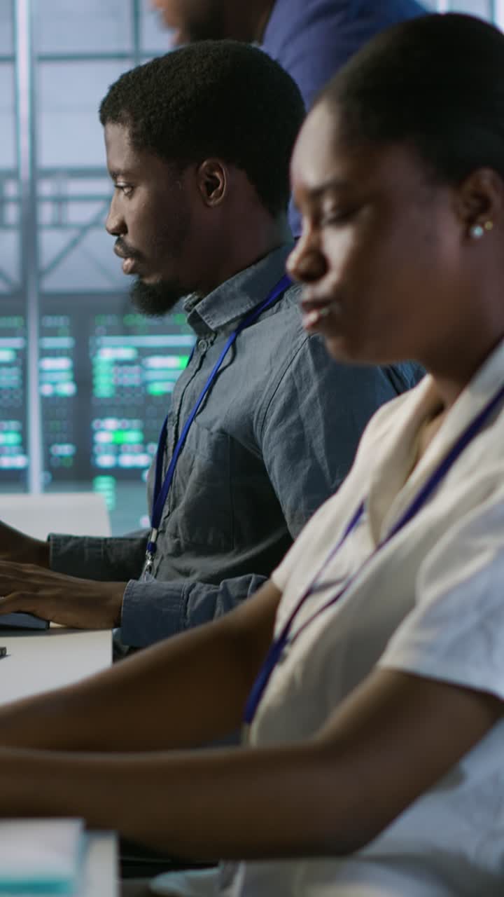 Vertical video Employee entering data center, beginning job shift, monitoring performance