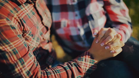happy couple holding hands. couple holding hands in a field. walking together in the nature
