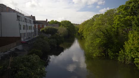 view of river liffey entering dublin city, ireland - tilt up shot