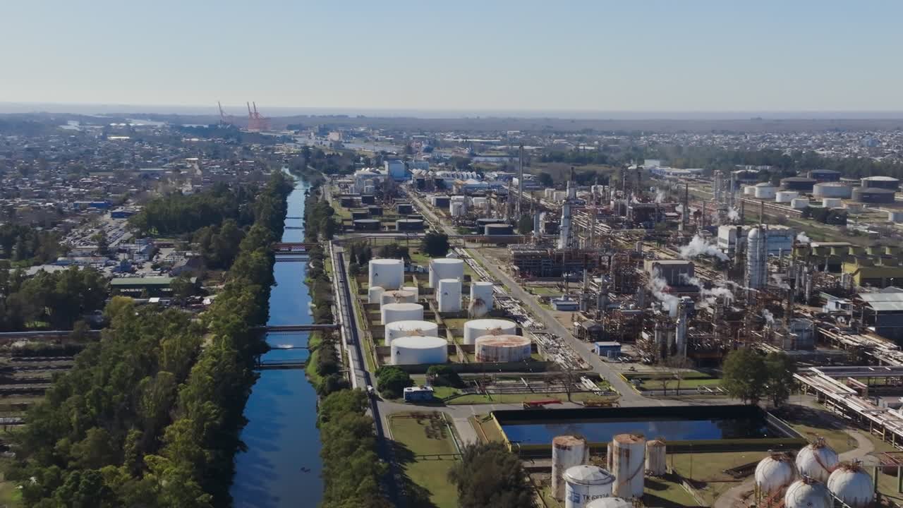 Drone shot of oil tanks and refinery in suburban industrial area, daytime