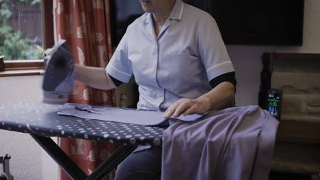 woman ironing a shirt at home