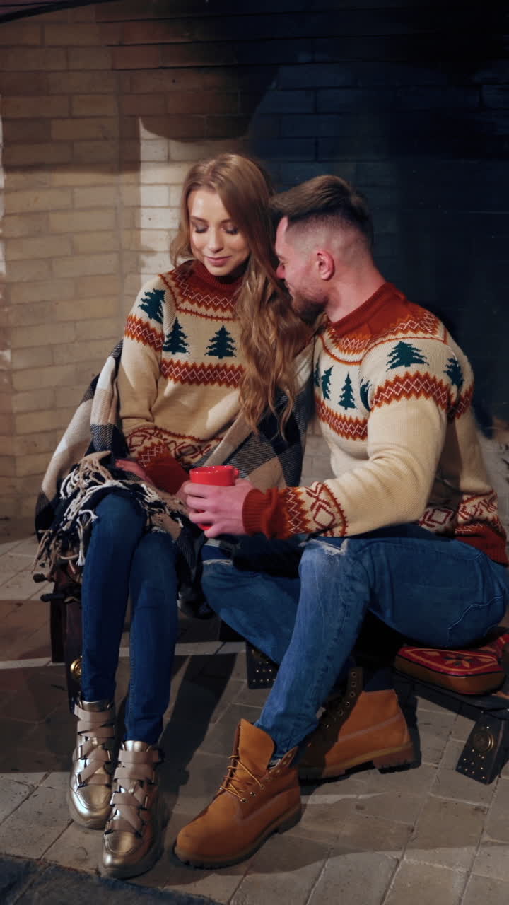 Couple in love in cozy Christmas house. Young people enjoying time together during winter holidays. Romantic evening indoors. Vertical video