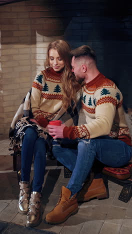 couple in love in cozy christmas house. young people enjoying time together during winter holidays. romantic evening indoors. vertical video