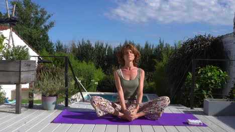 young caucasian woman warming up for her daily morning yoga practice