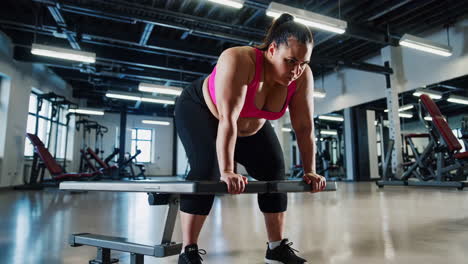plus-size woman weightlifting in gym